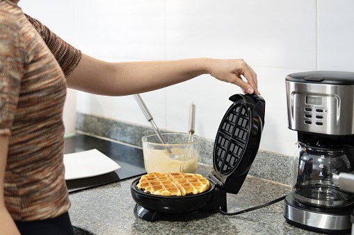  A Woman is Making the Waffle